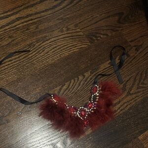 Deep red bejeweled necklace with feather detailing
